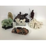 A mixed lot of seven items including a jadeite elephant on stand, a soapstone dragon, monkeys,