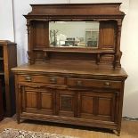 A late Victorian oak mirror back sideboard, the raised back incorporating a bevelled mirror plate