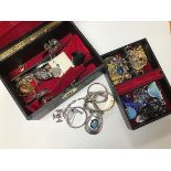 A mixed lot of jewellery including two boxes with silver bangles, yellow metal earrings, glass