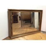A rectangular wall mirror within a moulded gilt frame (67cm x 92cm)