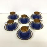 A set of six demi tasse cups and saucers with a mottled lapis blue glaze, with Classical style