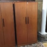 A mid century G Plan single wardrobe, the pair of cupboard doors enclosing hanging space with two