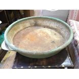 A large Victorian circular steel country house kitchen cauldron with spout to one side and cast iron