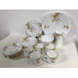 A Crown china set with an autumnal floral pattern including five teacups, six saucers, six side