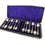 A case containing a set of twelve Epns engraved handle teaspoons with matching tongs in original