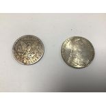 An Austrian white metal coin dated 1780 and an American silver dollar, dated 1886 (54.57g)