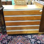 A 1960s teak and metal bound chest of drawers, the rectangular top above four drawers, raised on a