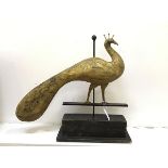 A treen American folk art style peacock weather vane raised on anodised metal post (h.58cm)