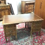 A mid 20thc desk, the rectangular top with moulded edge above two banks of three drawers, the