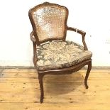 A French carved fauteuil, the cartouche shaped back and seat, with shaped squab cushion, with