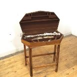 An early 19thc oak cutlery canteen and stand, the canted front enclosing a baize lined interior with