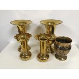 Two brass vases of baluster form with splay lips, two smaller vases with scalloped splay lips with