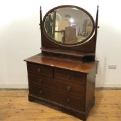 An Edwardian mahogany and satinwood banded dressing chest, the raised superstructure with oval