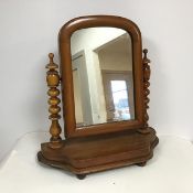 A mid 20thc dressing table mirror, the glass in arched frame flanked by bobbin turned supports, on