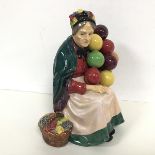 A Royal Doulton figure of The Old Balloon Seller, stamped to base, HN1315