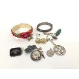 A mixed lot including a hollow filled stiff hinged bangle, a silver gilt mounted crystal drop, a