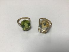 A 9ct gold dress ring set oval citrine in claw setting and a 9ct gold peridot set ring (P) (9.7g) (