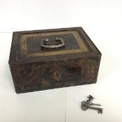 An early 20thc painted metal strongbox with a gilt and geometric design hinged top exposing a red