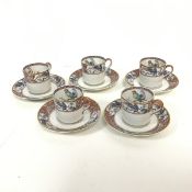 A set of five Limoges demi tasse cups and saucers, the cups with gilt edge and handle, with