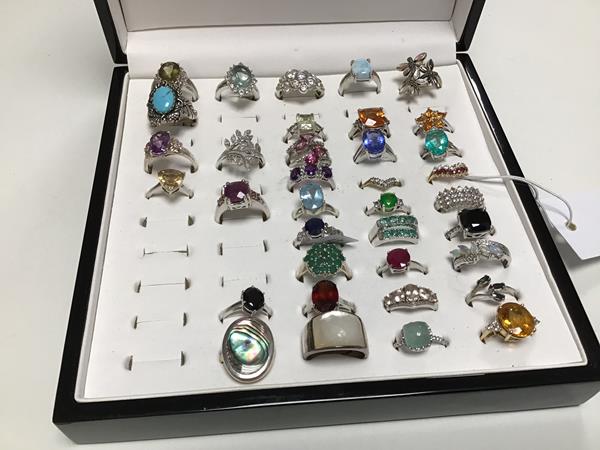 Thirty six white metal and silver rings, some set semi precious stones, various colours and