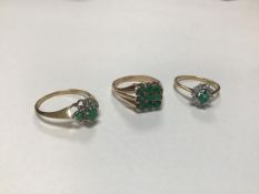 A 9ct gold oval emerald and diamond cluster set ring set ten diamonds (N), a 9ct gold three stone