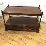 A reproduction two tier table, the rectangular top with shallow gallery and finial to each corner,