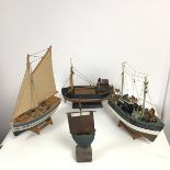 A model of a fishing trawler on a fixed stand, a second model of a fishing trawler also on fixed