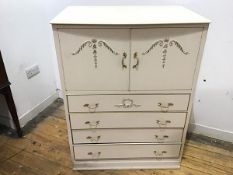 A 1950s white painted bedroom cabinet, with pair of cupboard doors applied with trailing harebells