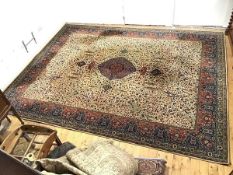 A Wilton machine made carpet, the ivory field with central indigo medallion decorated with