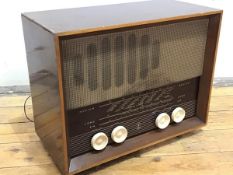 A Ferranti walnut cased mid century radio, with medium, long and FM, with four cream plastic nobs,