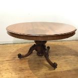 A large mid 19thc mahogany breakfast table, the circular top with moulded edge raised on a broad