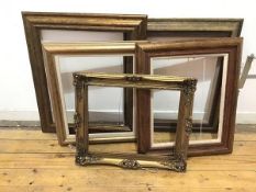 A set of five gilt picture frames, all moulded, two with carving, one composite (largest: 68cm x