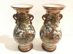 A pair of Japanese Satsuma baluster vases decorated with figures beside a lake and Samuri