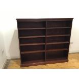 A modern mahogany open bookcase, the projecting top above a dentil cornice fitted eight adjustable