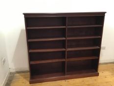 A modern mahogany open bookcase, the projecting top above a dentil cornice fitted eight adjustable
