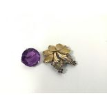 A 9ct gold crysanthemum leaf and floral brooch set three sapphires to each flower, with a clip