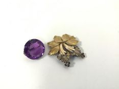 A 9ct gold crysanthemum leaf and floral brooch set three sapphires to each flower, with a clip