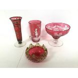 A Mary Gregory cranberry glass tumbler (h.9cm), a cranberry glass bud vase with overlaid white metal