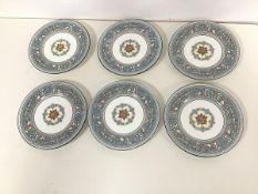 A set of six Wedgwood Florentine pattern plates, the border enclosing a floral and mythical creature