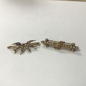 A 9ct gold bar brooch mounted a central strand of eleven seed pearls, with two barley twist supports