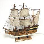 A ship's model, The Mayflower, complete with sails, rigging, canons, and anchor, all on stand with