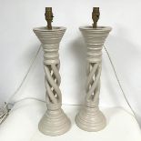 A pair of treen table lamps with pierced spiral stems, with moulded top and base, possibly