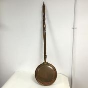 A bed warming pan with hinged copper pan with turned wooden handle (l.105cm x d.28cm)