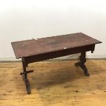 An early 20thc painted trestle table, the rectangular top on vase shaped supports, formerly with