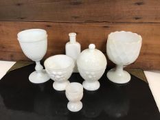 A collection of milk glass including a goblet with spiked body and faceted stem and foot, another