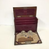 An early 20thc oak travelling stationery box, the hinged rectangular top with a metal shield