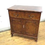 A walnut side cabinet of Georgian design, the rectangular crossbanded top with moulded edge above