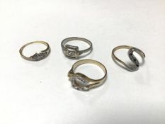 A mixed lot of four rings including an 18ct gold gem set ring, a 9ct gold S shaped ring, a white