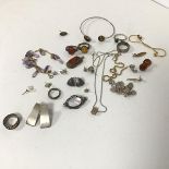 A mixed lot of jewellery including silver earrings and rings, a mother of pearl brooch, amber rings,