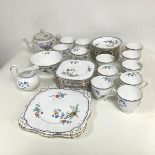 A Tuscan china teaset comprising twelve cups and saucers, eleven tea plates, two sandwich plates,